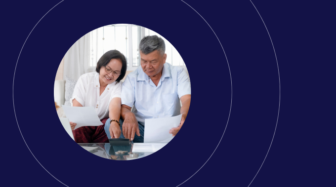 A happy couple sitting down reviewing bills